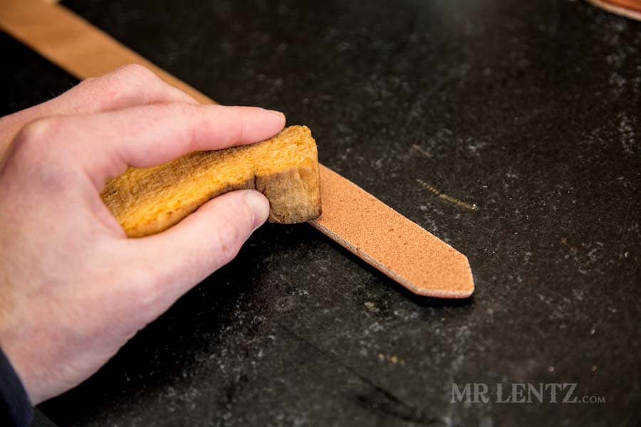 wetting the strap edges in preparation to bevel