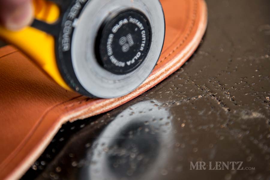 trimming the edge of the weld on an axe sheath