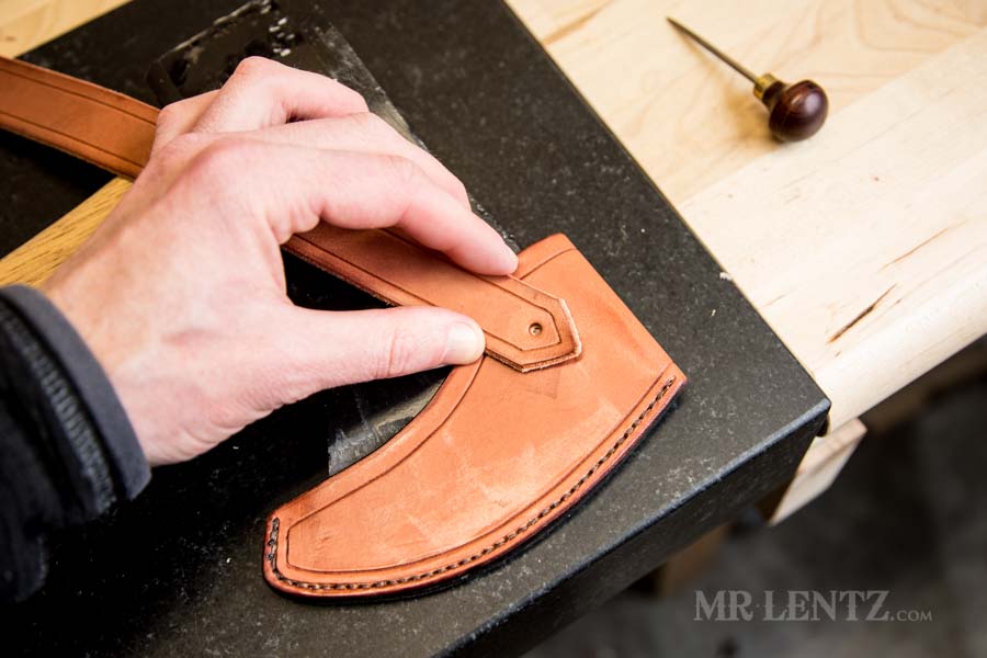 fitting the retaining strap on an axe sheath