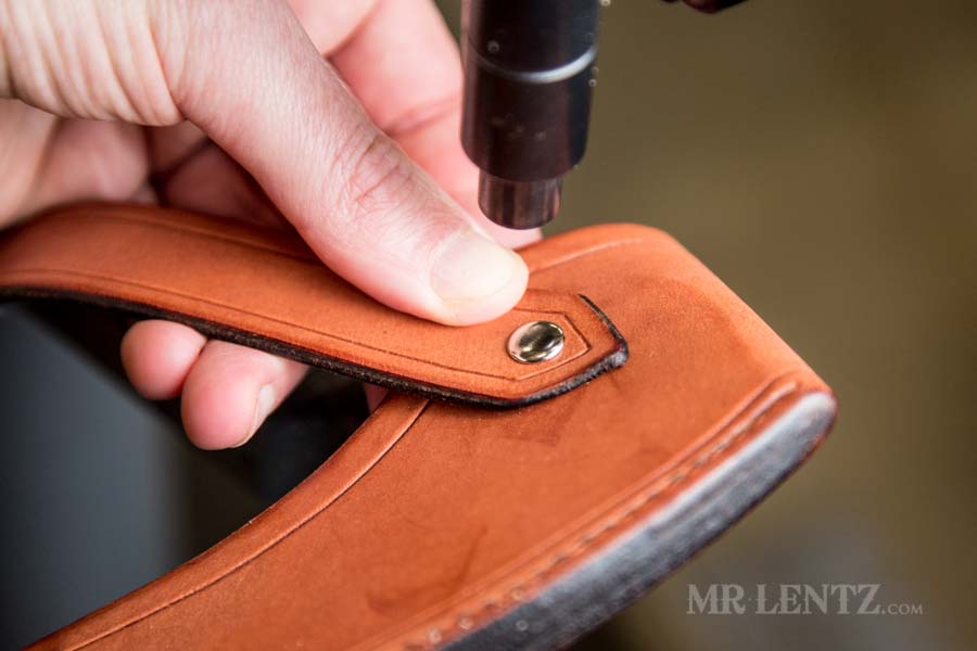 pressing rivet in strap on sheath