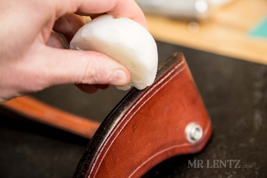 rubbing beeswax into the edge of axe sheath