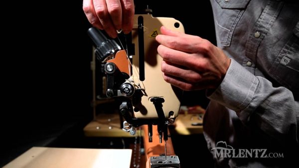 feeding thread through take up lever on leather sewing machine