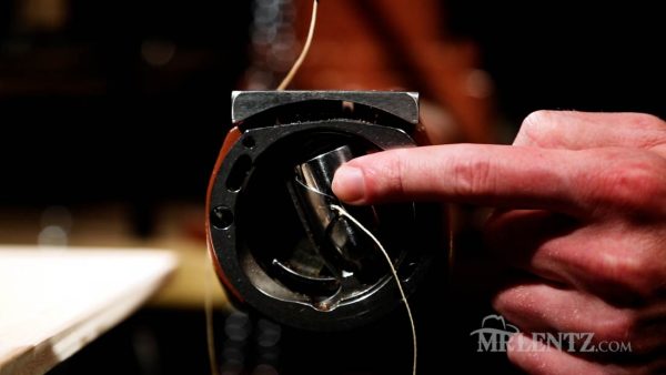 pushing bobbin thread and container back into place