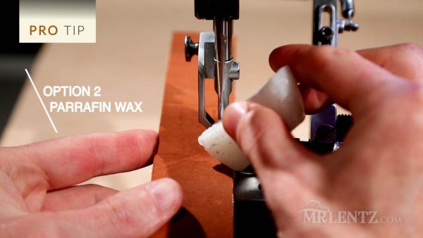 waxing the needle on a leather sewing machine