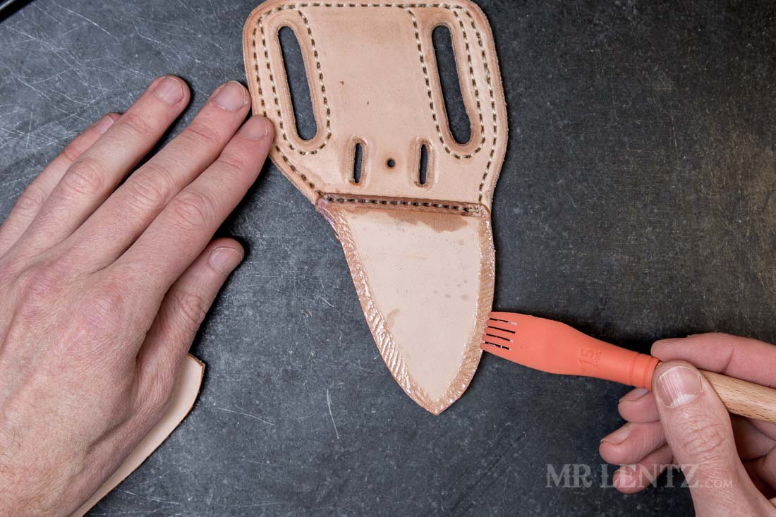 applying glue on the welt used in leather knife sheath making
