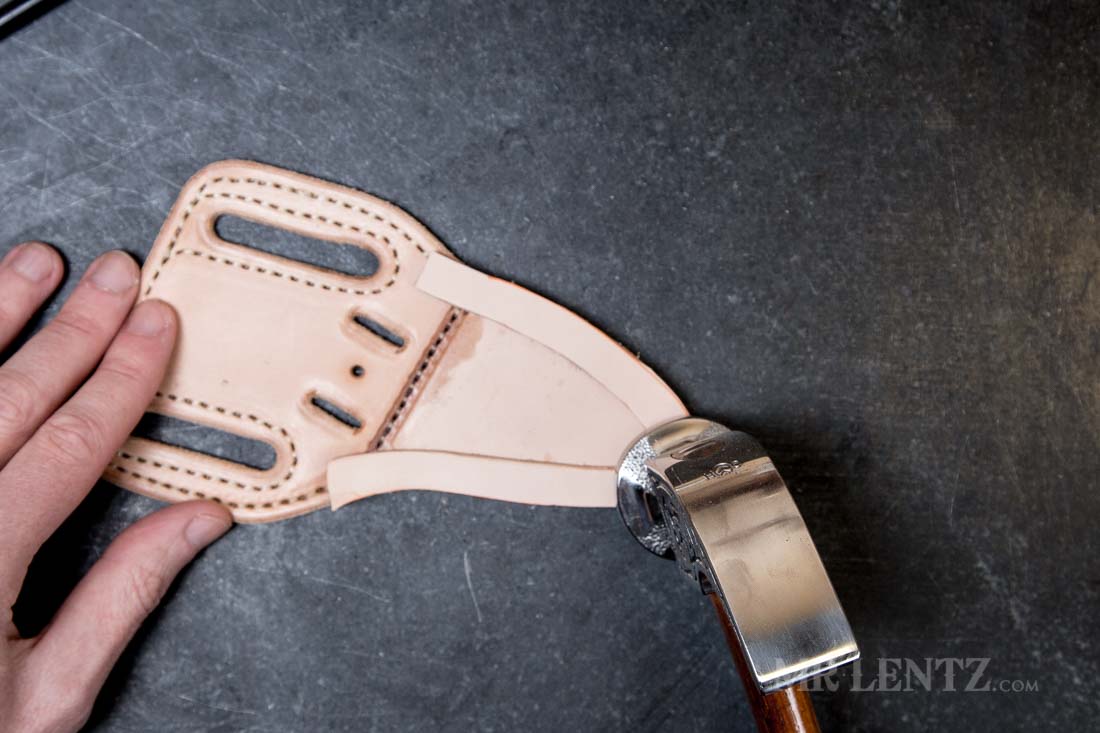 hammering the edge on a glued welt in a knife sheath