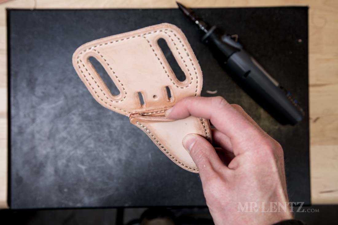 pulling open the leather sheath