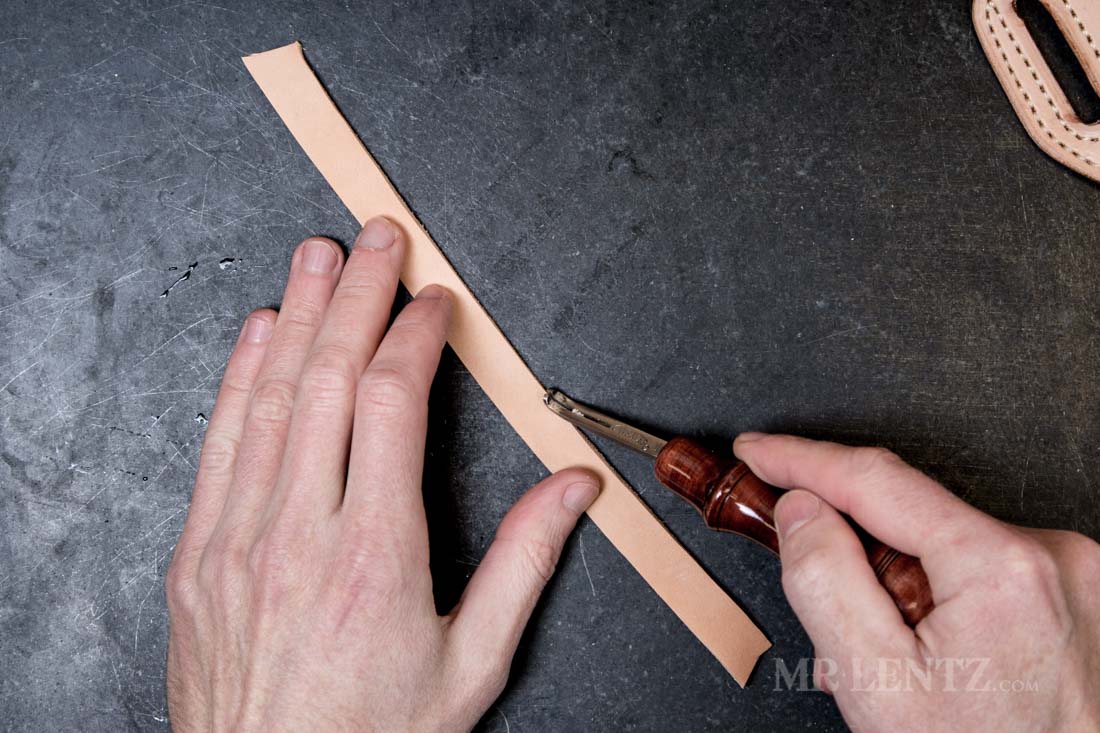 beveling the edge of the retaining strap