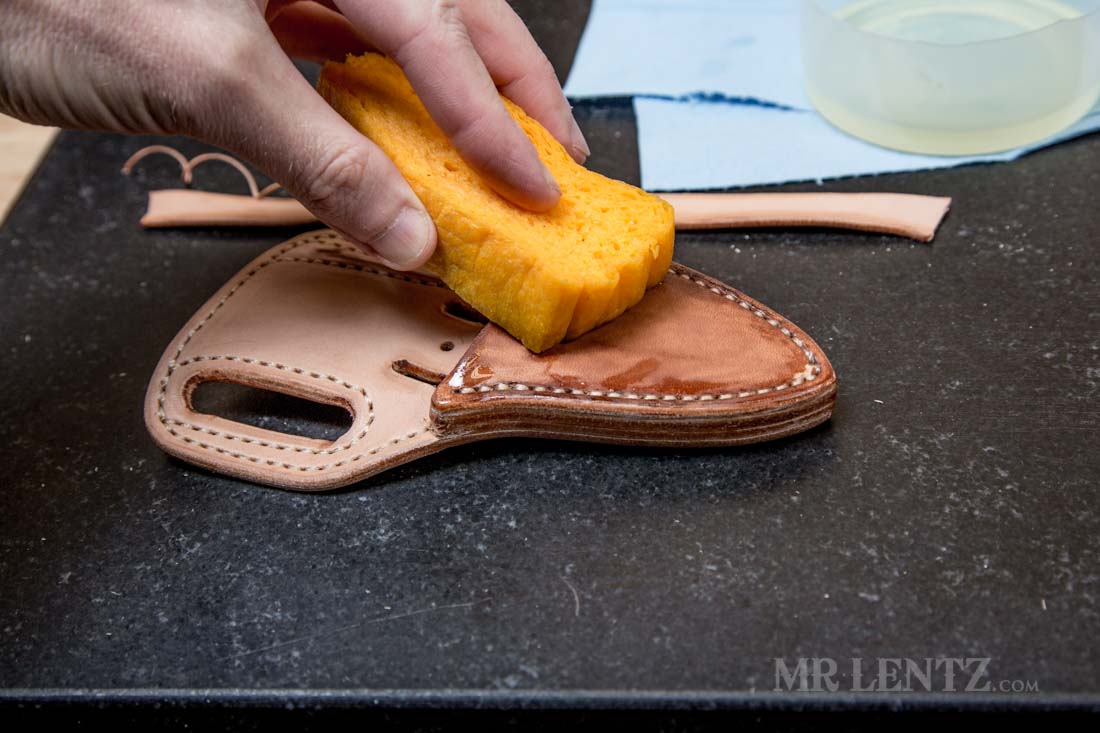 applying neatsfoot oil to a retaining strap