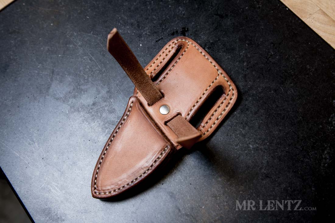 riveting the retaining strap in place