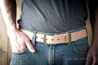 wearing a tan leather gun belt