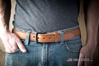 brown belt with black hardware lined and stitched