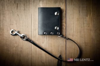 leather chain on black trifold snap wallet