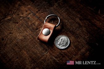 the worlds smallest keychain next to a dime